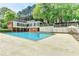 Community pool with lounge chairs and mature trees in the background at 30 Plantation Ne Dr # B, Atlanta, GA 30324