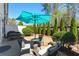 Cozy backyard patio with green foliage, complete with a teal umbrella, seating, and a grill at 3172 Havencroft Ne Dr, Roswell, GA 30075