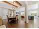 Open-concept dining room with hardwood floors, chandelier, and view of the living room and kitchen at 3172 Havencroft Ne Dr, Roswell, GA 30075