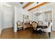 Dining room showcases hardwood floors, beamed ceiling, and chandelier with easy access to the kitchen at 3172 Havencroft Ne Dr, Roswell, GA 30075