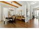 Dining room features hardwood floors, beamed ceiling, and elegant chandelier at 3172 Havencroft Ne Dr, Roswell, GA 30075