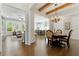 Open-concept dining room with wood beams, chandelier, and hardwood flooring at 3172 Havencroft Ne Dr, Roswell, GA 30075