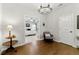 Hallway with a decorative chandelier and doorway views into a bedroom at 3172 Havencroft Ne Dr, Roswell, GA 30075