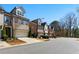 Street view of modern townhomes featuring brick and neutral siding with attached garages at 3172 Havencroft Ne Dr, Roswell, GA 30075