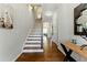 Inviting foyer with hardwood floors, staircase, and stylish decorative accents at 3172 Havencroft Ne Dr, Roswell, GA 30075