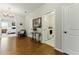 Inviting hallway with hardwood floors, elegant lighting, and views into the laundry and bedroom at 3172 Havencroft Ne Dr, Roswell, GA 30075