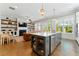 Modern kitchen island with stainless steel appliances and view into living room with fireplace at 3172 Havencroft Ne Dr, Roswell, GA 30075