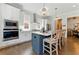 Modern kitchen with large island, stainless steel appliances, and hardwood floors at 3172 Havencroft Ne Dr, Roswell, GA 30075