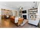 Open-concept living room with hardwood floors, a fireplace, and views of the dining room and kitchen at 3172 Havencroft Ne Dr, Roswell, GA 30075