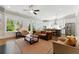 Bright living room with an open kitchen and stainless appliances, complemented by hardwood floors and large windows at 3172 Havencroft Ne Dr, Roswell, GA 30075