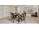 Basement area with a dining table and chairs, sofa, and neutral walls at 7170 Highbrook E Cir, Cumming, GA 30041