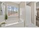 Inviting soaking tub with views of nature, perfect for relaxation, next to shower at 7170 Highbrook E Cir, Cumming, GA 30041