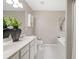 Bathroom featuring double sinks, white marble floors and vanity, bathtub and artwork at 7170 Highbrook E Cir, Cumming, GA 30041