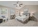 Comfortable bedroom with vaulted ceiling, ceiling fan, and natural light from large windows at 7170 Highbrook E Cir, Cumming, GA 30041
