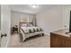 Cozy bedroom with soft carpet, wooden bed frame, and natural light from the window at 7170 Highbrook E Cir, Cumming, GA 30041