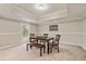 Cozy dining room with a wooden table, chairs, bench, and a door to the outside at 7170 Highbrook E Cir, Cumming, GA 30041