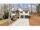 Inviting home with a two-car garage, front porch, and manicured landscaping on a sunny day at 7170 Highbrook E Cir, Cumming, GA 30041
