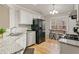 Well-lit kitchen with granite countertops, stainless steel appliances, and a breakfast nook by the window at 7170 Highbrook E Cir, Cumming, GA 30041