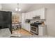 Charming kitchen featuring white cabinets, stainless steel appliances, and granite countertops at 7170 Highbrook E Cir, Cumming, GA 30041
