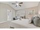 Bright main bedroom with vaulted ceiling, ceiling fan, and natural light from large windows at 7170 Highbrook E Cir, Cumming, GA 30041