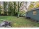 View of the backyard showing the house and lawn at 1753 Beechwood Sw Blvd, Atlanta, GA 30311