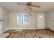 Living area with ceiling fan, natural light, and potential for updates to flooring and walls at 1753 Beechwood Sw Blvd, Atlanta, GA 30311