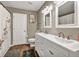 Well-lit bathroom with double vanity, tub and shower with tasteful decorations at 214 Walton St, Loganville, GA 30052