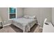 Bedroom featuring a queen-size bed, neutral carpet, and a large window for light at 214 Walton St, Loganville, GA 30052