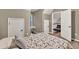 Bedroom features a bed, table, and a view into a room with black lounge chair at 214 Walton St, Loganville, GA 30052