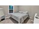 Cozy bedroom featuring a comfortable bed, a window, and a full-length mirror at 214 Walton St, Loganville, GA 30052