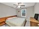 Cozy bedroom with ceiling fan and natural light from the window at 214 Walton St, Loganville, GA 30052