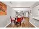 Open floor plan with a dining area featuring wood-look floors and views into the living room at 214 Walton St, Loganville, GA 30052