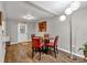 Cozy dining area with wood-look floors, a round table with red chairs, and modern lighting at 214 Walton St, Loganville, GA 30052