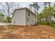 Rear exterior showcasing a two-story home with durable siding and a spacious yard at 214 Walton St, Loganville, GA 30052