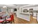 Open-concept kitchen and dining area with wood-look floors and modern stainless steel appliances at 214 Walton St, Loganville, GA 30052