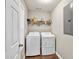 Convenient laundry room equipped with a side-by-side washer and dryer at 214 Walton St, Loganville, GA 30052