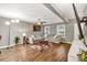 Comfortable living room featuring a large gray sectional sofa, wood floors, and natural light at 214 Walton St, Loganville, GA 30052