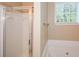 Modern bathroom with shower, tub and window providing natural light at 2368 Barrett Cottage # 17, Marietta, GA 30066