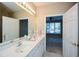 Bright bathroom featuring double sinks, and an open doorway to the bedroom at 2368 Barrett Cottage # 17, Marietta, GA 30066