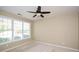 This cozy bedroom has a ceiling fan and a large window that provides natural light at 2368 Barrett Cottage # 17, Marietta, GA 30066