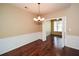 This elegant dining room boasts hardwood floors, wainscoting, and a stylish chandelier at 2368 Barrett Cottage # 17, Marietta, GA 30066