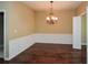 This elegant dining room boasts hardwood floors, wainscoting, and a stylish chandelier at 2368 Barrett Cottage # 17, Marietta, GA 30066