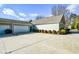 Back exterior view of building with garage doors and ample parking at 2368 Barrett Cottage # 17, Marietta, GA 30066