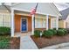 Inviting brick entryway with an American flag, blue door adorned with a wreath, and manicured bushes at 2368 Barrett Cottage # 17, Marietta, GA 30066