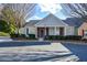 Charming single-story home with blue door, neat landscaping, and ample parking on a sunny day at 2368 Barrett Cottage # 17, Marietta, GA 30066