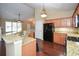 Open kitchen with granite countertops, wood cabinets, stainless appliances, and breakfast bar overlooking the living area at 2368 Barrett Cottage # 17, Marietta, GA 30066