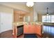 Stylish kitchen with granite countertops, wood cabinets, and stainless steel dishwasher, leading to an open floor plan at 2368 Barrett Cottage # 17, Marietta, GA 30066