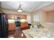 Kitchen with granite countertops, stainless steel appliances, and wooden cabinets, open to the living area at 2368 Barrett Cottage # 17, Marietta, GA 30066