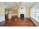 Spacious living room with hardwood floors, a fireplace, and large windows, seamlessly connecting to other rooms at 2368 Barrett Cottage # 17, Marietta, GA 30066