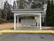 Organized community mailboxes sheltered by a white structure with natural landscaping at 2368 Barrett Cottage # 17, Marietta, GA 30066